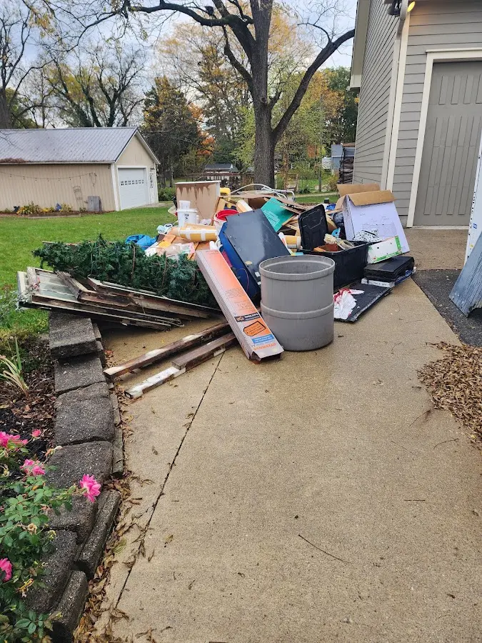 Dumpster being loaded with debris for Estate Cleanout Dumpster Rental in Starke